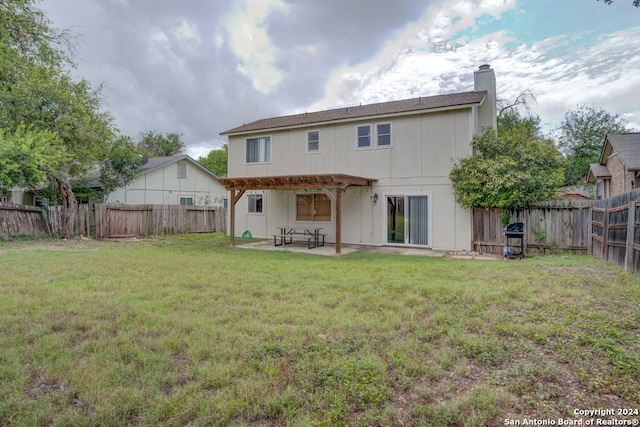 back of property featuring a patio and a lawn