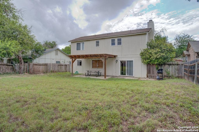 rear view of house with a pergola, a yard, and a patio area