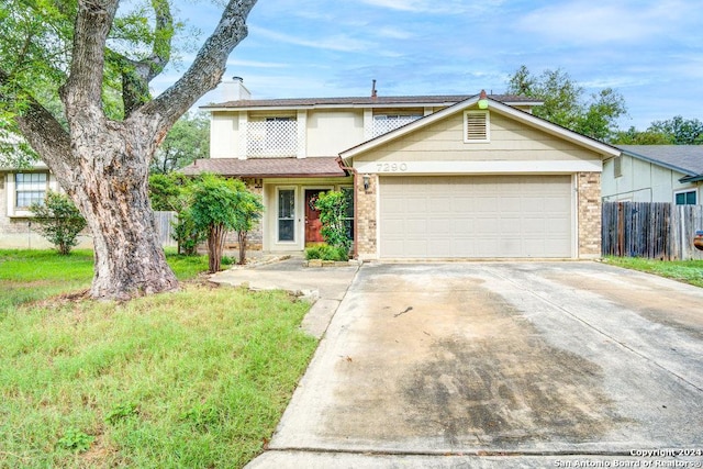 view of front of property with a garage and a front lawn