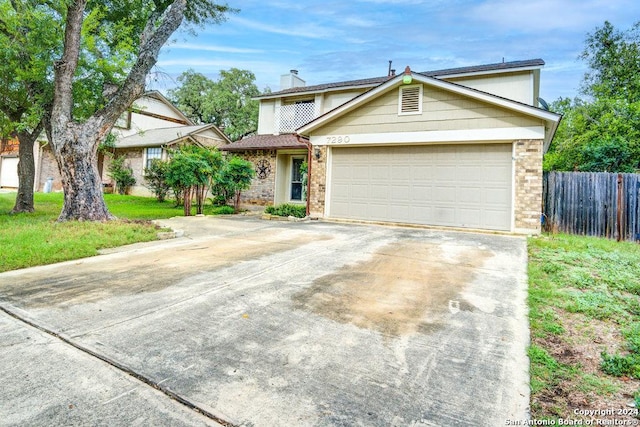 view of front of home with a garage and a front lawn