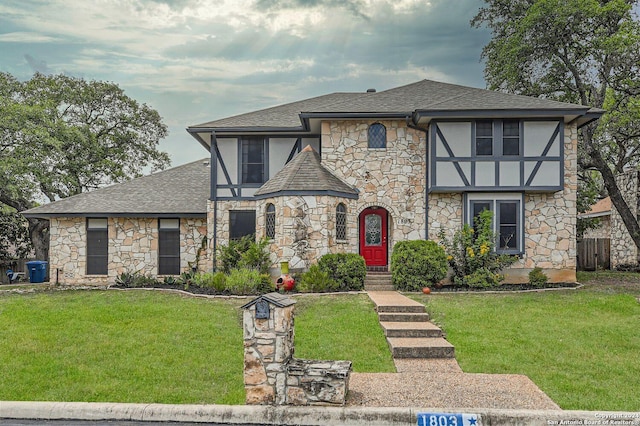 tudor home featuring a front lawn