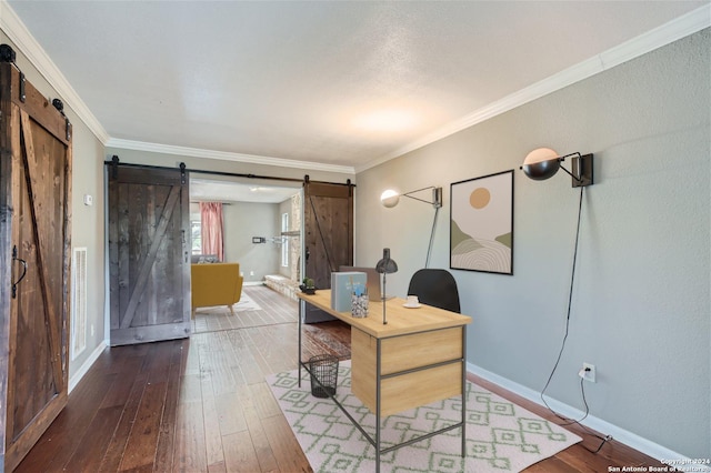 office area featuring crown molding, wood-type flooring, and a barn door