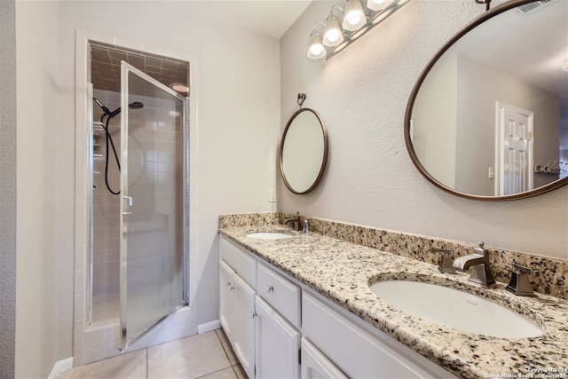 bathroom featuring an enclosed shower, vanity, and tile patterned floors