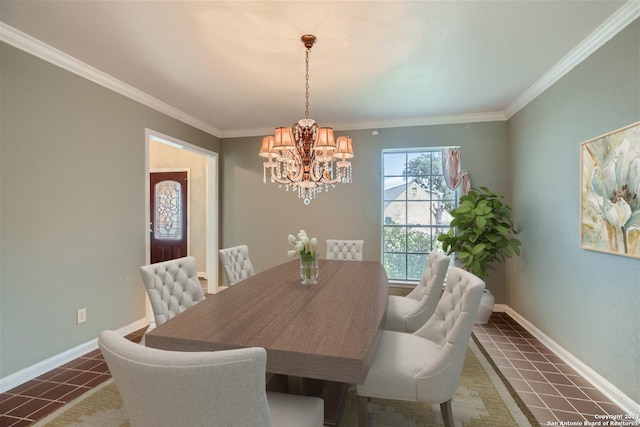 dining space featuring a notable chandelier, ornamental molding, and dark tile patterned floors