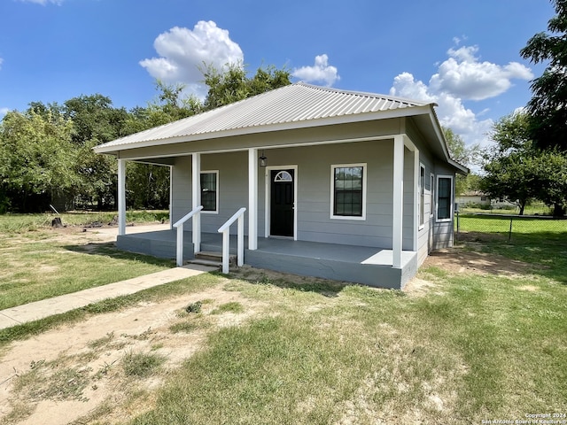 view of front of home with a front yard and covered porch