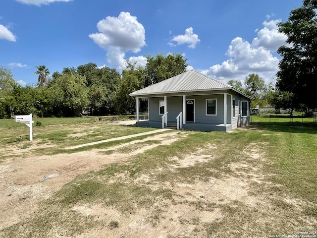 view of front of home featuring a front yard and a porch