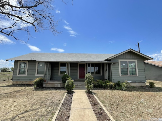view of front facade with roof with shingles and covered porch