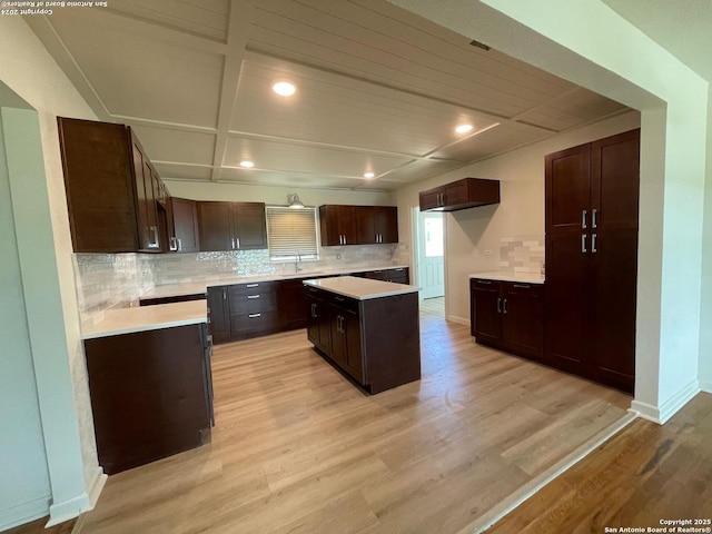 kitchen with decorative backsplash and light wood-style flooring