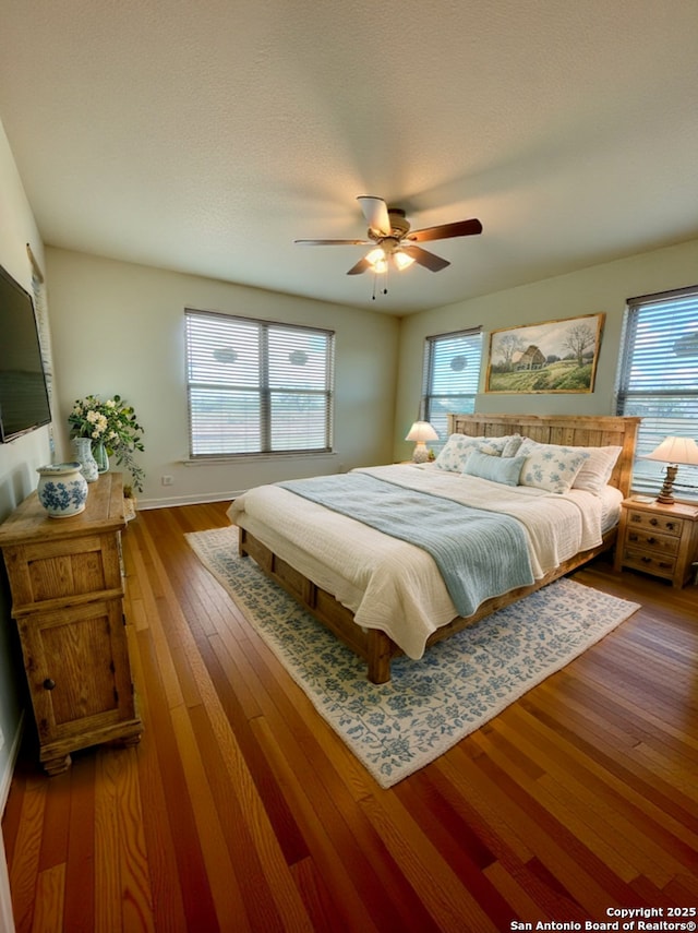 bedroom with hardwood / wood-style floors and ceiling fan