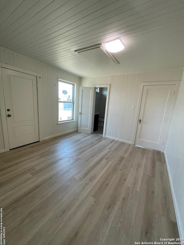 interior space with baseboards and light wood-type flooring