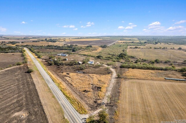 birds eye view of property with a rural view