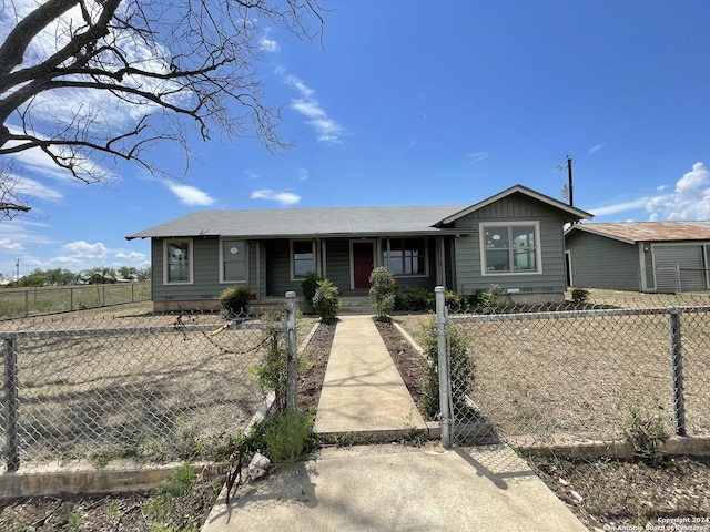 view of front of home with a gate, covered porch, and a fenced front yard