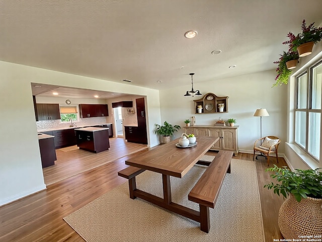 dining area with light wood finished floors, recessed lighting, and baseboards