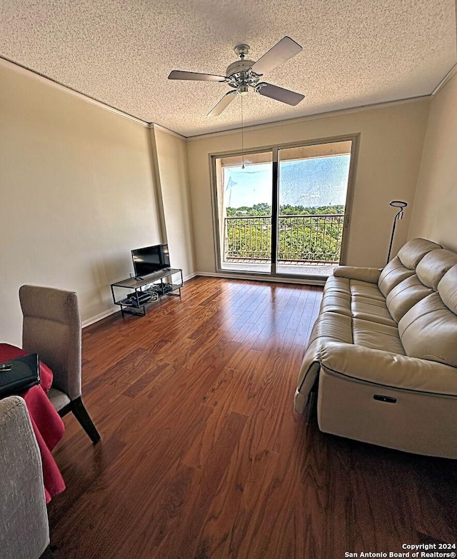 living room with ceiling fan, wood-type flooring, crown molding, and a textured ceiling