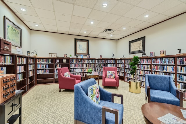 living area with carpet and a drop ceiling