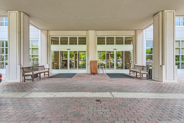 view of exterior entry with french doors and a patio area