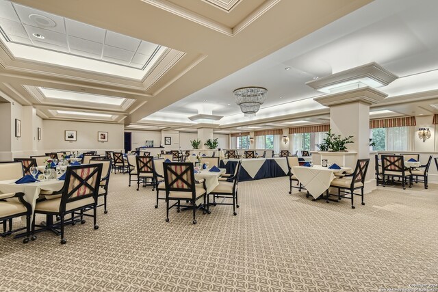 carpeted dining area with crown molding and a tray ceiling