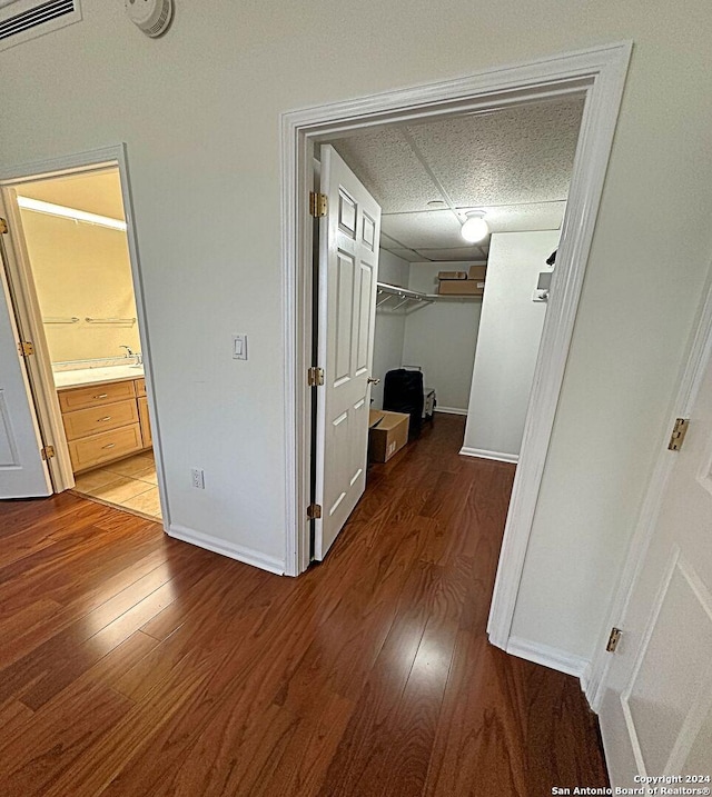 corridor with hardwood / wood-style floors