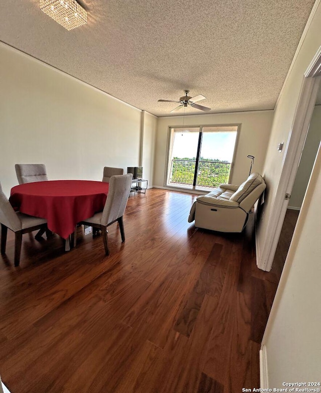 dining space with ceiling fan, dark hardwood / wood-style floors, and a textured ceiling