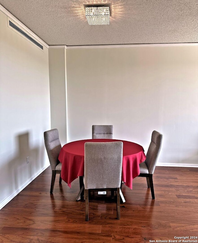 dining space featuring dark hardwood / wood-style floors and a textured ceiling