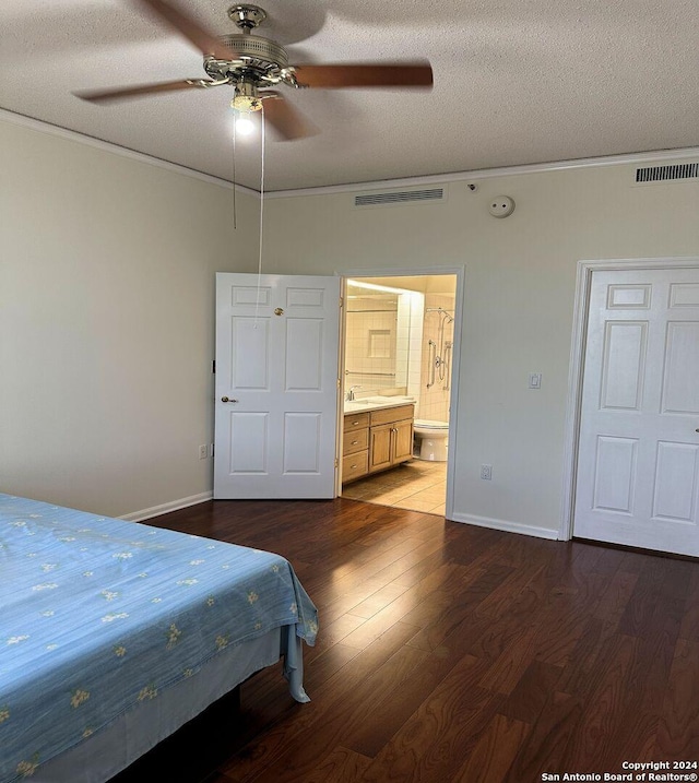 bedroom featuring ceiling fan, a textured ceiling, ornamental molding, and hardwood / wood-style floors