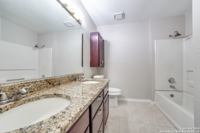 full bathroom with tile patterned floors, double vanity, shower / tub combination, toilet, and a textured ceiling