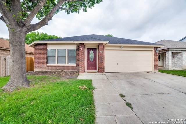 ranch-style home with a garage and a front yard