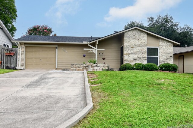 ranch-style house with a garage and a front yard