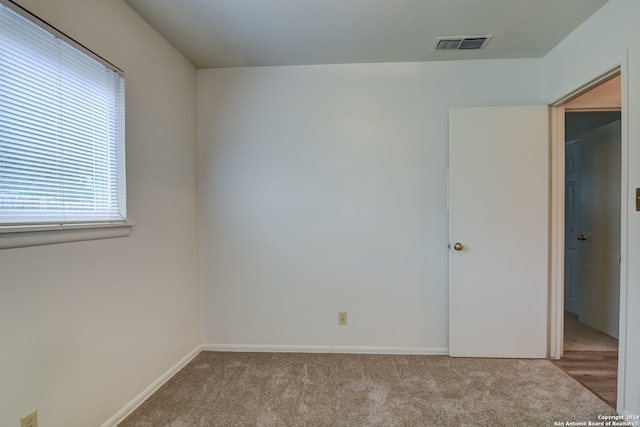 unfurnished room with light colored carpet