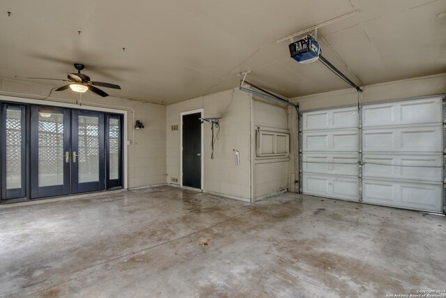 garage with a garage door opener and ceiling fan