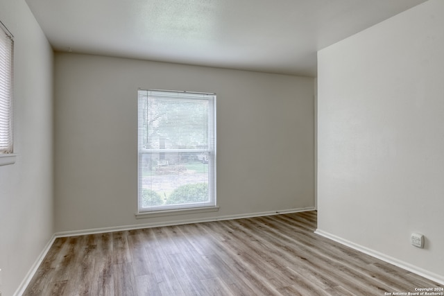 spare room with hardwood / wood-style floors