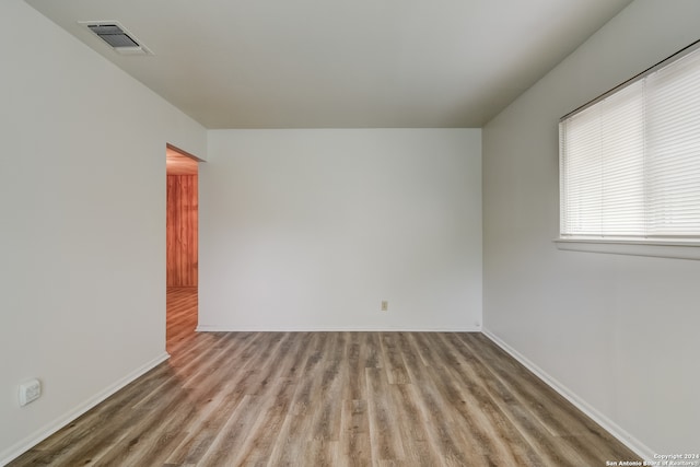 unfurnished room featuring hardwood / wood-style flooring