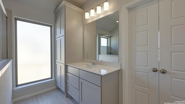 bathroom with vanity and a shower with shower door