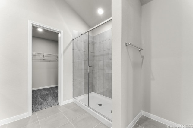 bathroom featuring tile patterned flooring and an enclosed shower