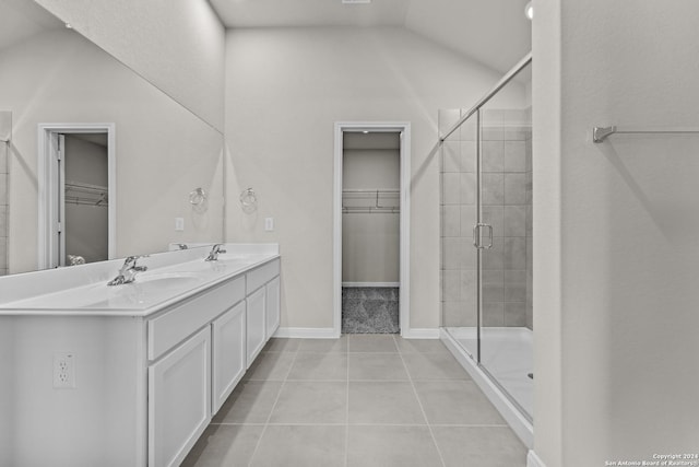 bathroom with vanity, tile patterned floors, a shower with shower door, and lofted ceiling