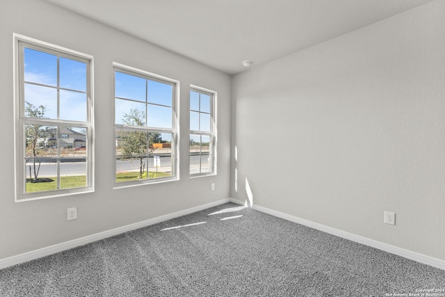 carpeted empty room with plenty of natural light