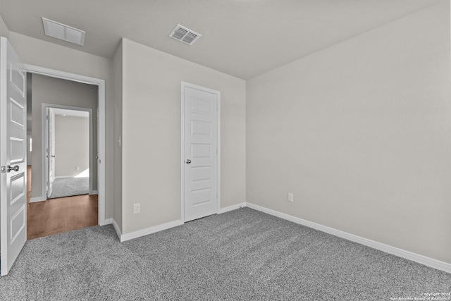 unfurnished bedroom with carpet and a closet