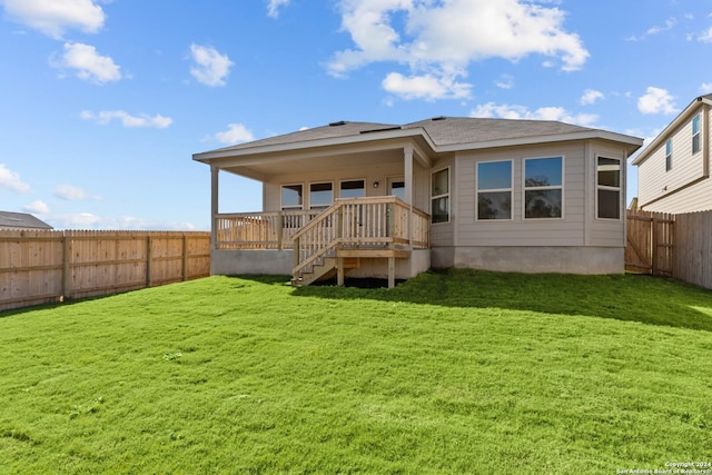 back of house featuring a yard and a deck