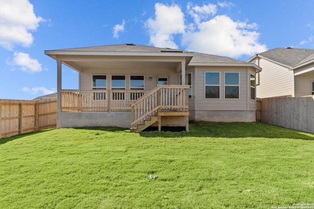 rear view of property with a yard