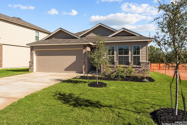 craftsman house featuring a garage and a front yard