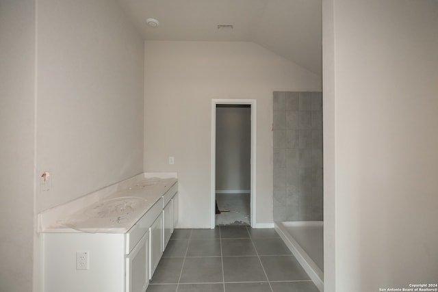 bathroom featuring vanity, vaulted ceiling, and tile patterned floors