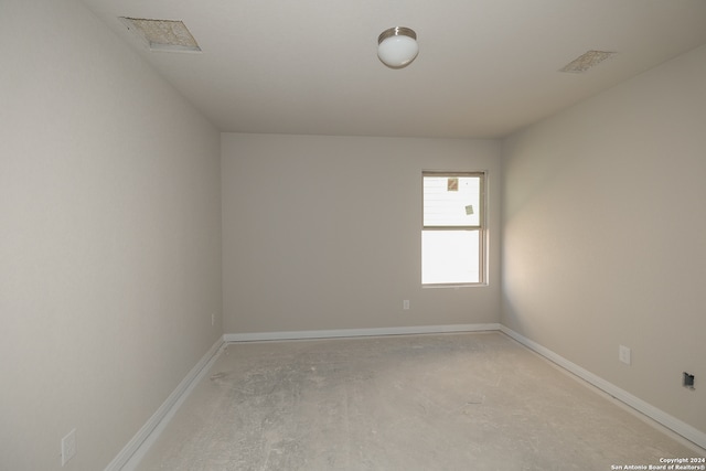 unfurnished room featuring concrete floors