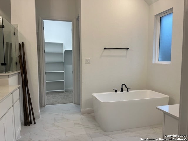 bathroom featuring vanity and plus walk in shower