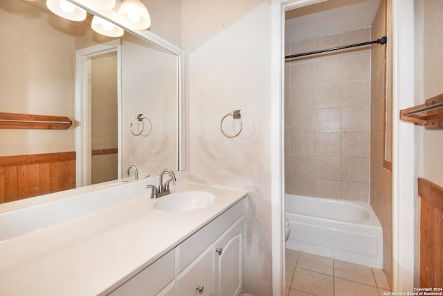 full bathroom with tile patterned flooring, toilet, vanity, and tiled shower / bath