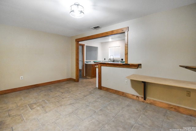 tiled spare room with sink