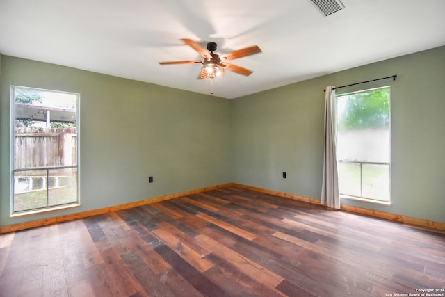 unfurnished room featuring ceiling fan, hardwood / wood-style flooring, and a wealth of natural light