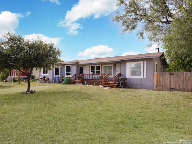 view of front of house featuring a wooden deck and a front yard