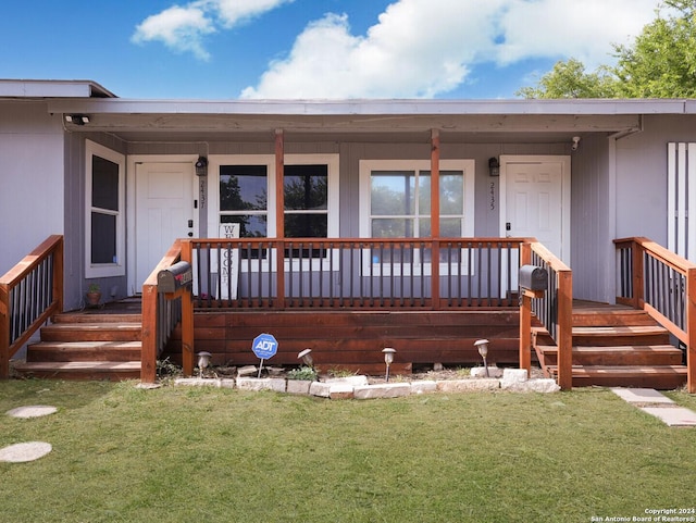 property entrance with a lawn and a porch