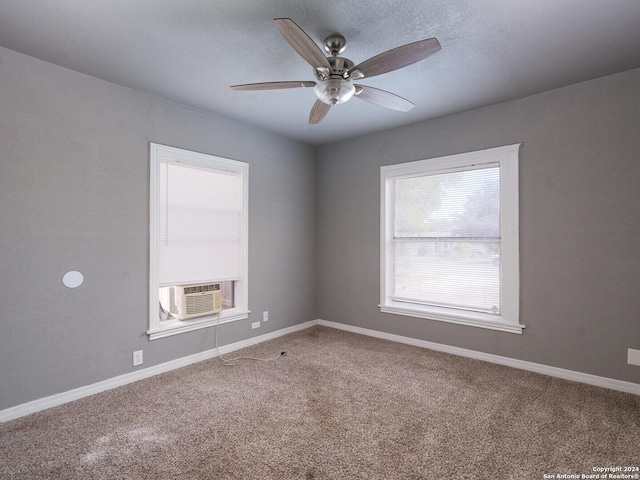 carpeted empty room with cooling unit and ceiling fan