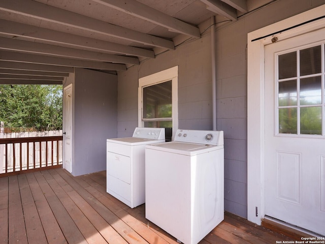 washroom featuring washing machine and clothes dryer and light hardwood / wood-style floors